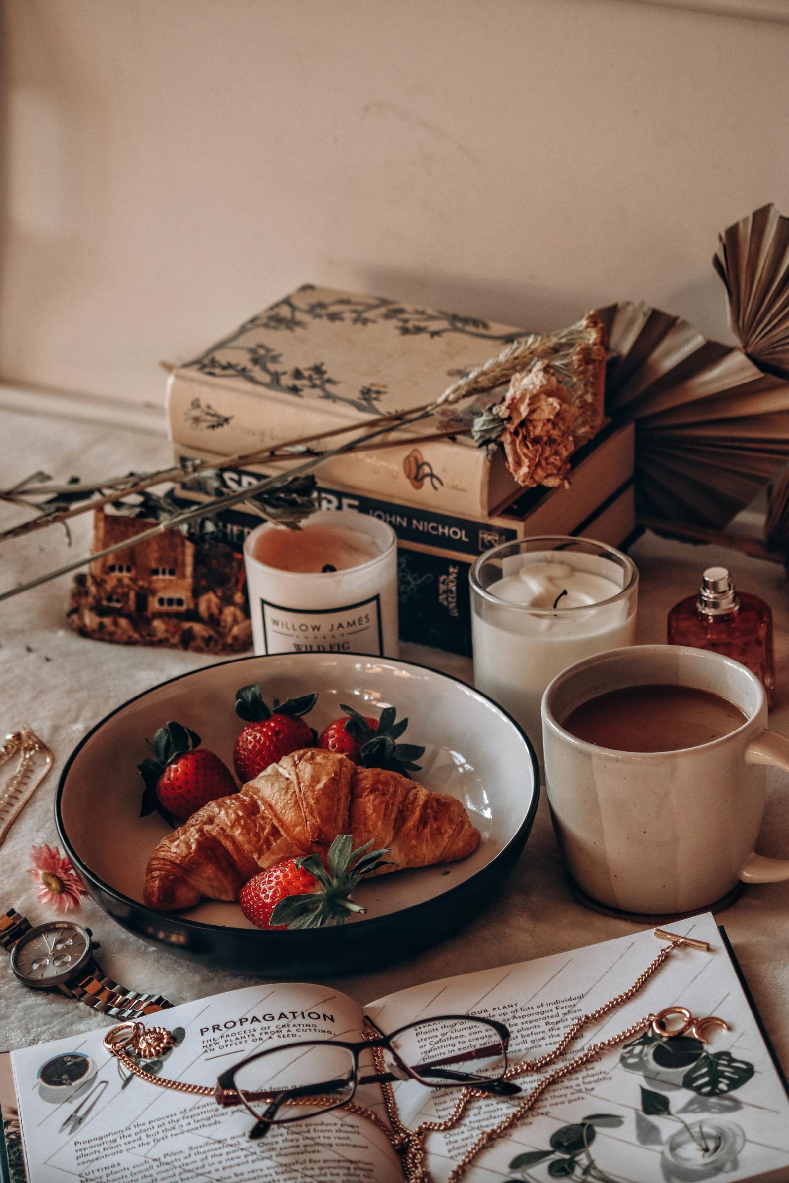 This images shows a breakfast set up with coffee and books